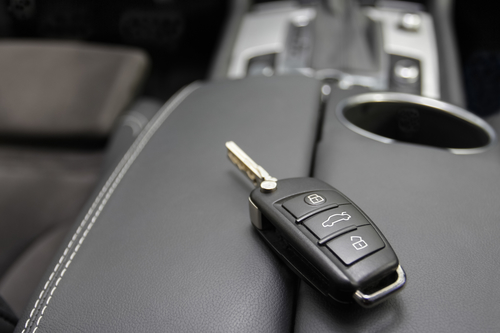 key to a luxury car. car key to a German luxury car, the key is lying on dark leather.
